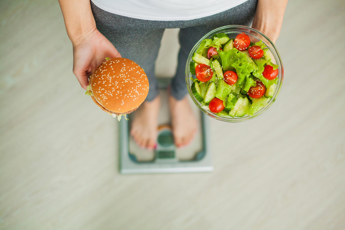 Seseorang sedang mengukur berat badan